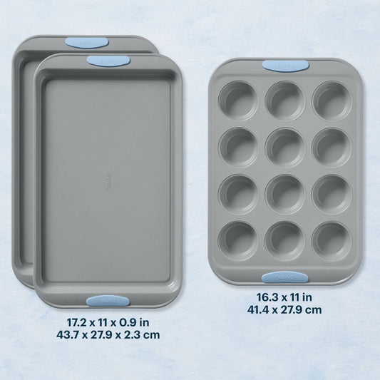 Set of three gray baking trays with blue silicone handles on a light blue background
