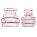 Set of glass food storage containers with red lids on a white background